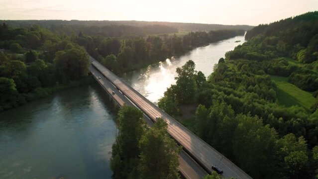 Cars Driving Rural America Bridge Crossing River at Sunset