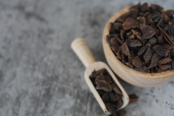 star anise in a wooden bowl on the table, close up