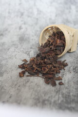 star anise in a wooden bowl on the table, close up