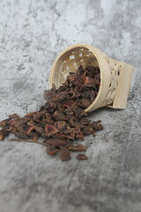 star anise in a wooden bowl on the table, close up