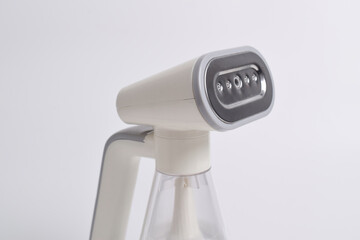 Hand steamer for clothes isolated on a white background. Portable home and travel garment steamer for clothes