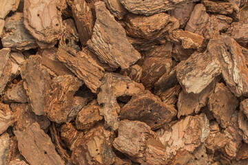 Small pieces of brown tree bark natural background texture decorative nature