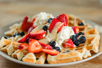 Golden Belgian Waffles topped with fruits and whipped cream