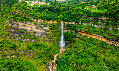 Aerial view of a waterfall in Barichara, Santander, Colombia, surrounded by lush greenery and rocky...