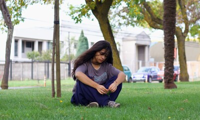 latin girl sitting in the park
