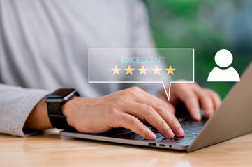 A man is typing on a laptop with a glowing star rating of 5 stars. Concept of accomplishment and satisfaction, as the man is likely receiving positive feedback or recognition for his work