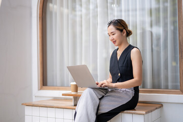 Businesswoman Planning with Laptop and Notebook