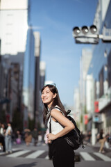 Tokyo vibes, A confident Japanese woman in her 30s, blending business, technology, and urban style while enjoying a leisurely walk. - 771945387