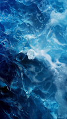Deep blue sea waves with frothy bubbles create a dynamic and textured aquatic surface.