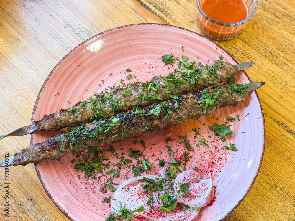 Sticker Shish kebab with meat in a plate on the table