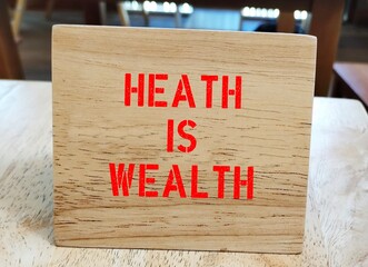 Wood stand with text written  HEALTH is WEALTH - Concept of work life balance - health is valuable...