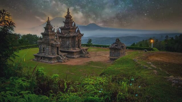 Gedongsongo temple at night with night sky and stars. Milkyway timelapse. Seamless looping 4k video background. 