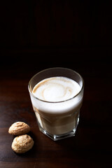 Coffee with milk on rustic wooden background. Soft focus. Close up. Copy space	