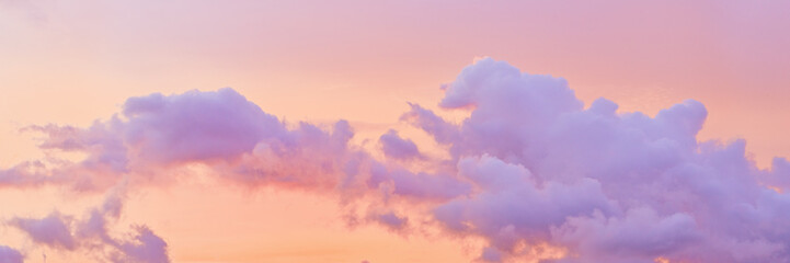 Aesthetic Pastel Sunset, violet fluffy clouds on pink peach colored sky, dreamy cloudscape pastel...