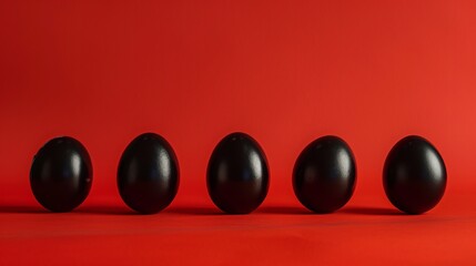 black eggs on red table