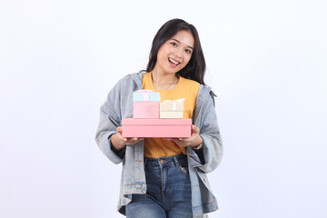 Happy beautiful Asian teen woman smiling hold in hand a lot of gift box  isolated on white...