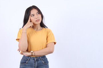 Beautiful young Asian girl thinking and looking upwards. The concept of content thinks about future...