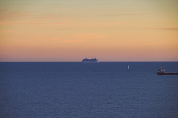 Modern cruiseship cruise ship liner Equinox cruising at sea with horizon and sunset twilight blue...