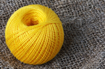 A skein of yellow thread on canvas. Yarn, ball, thread, fluffy, ball, handmade, craft, object, woolen, skein, material, homemade, hobby, traditional, creative