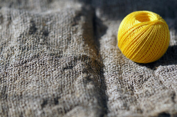 A skein of yellow thread on canvas. Yarn, ball, thread, fluffy, ball, handmade, craft, object, woolen, skein, material, homemade, hobby, traditional, creative