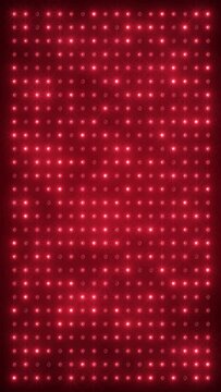 Vertical video animation of an abstract glowing red LED wall with bright light bulbs - abstract background.