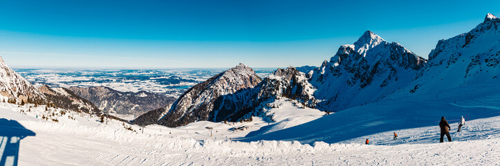 High resolution stitched alpine winter panorama with ski drivers at Mount Fuessener Joechle, Graen,...