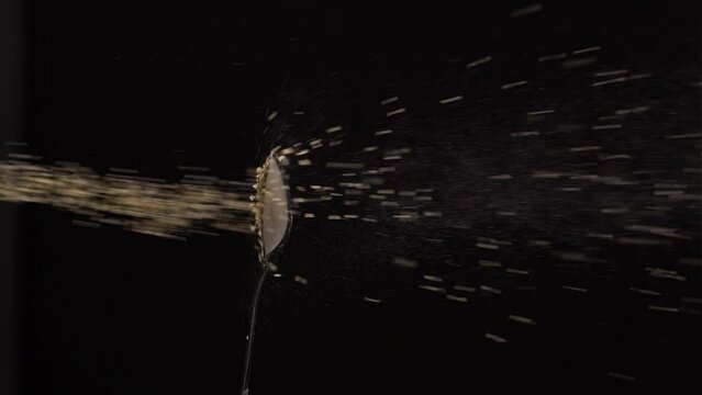 Dynamic floating the powder of the spoon against black background