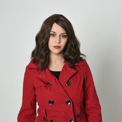 head and shoulders close up portrait of beautiful brunette woman model, wearing red trench coat...
