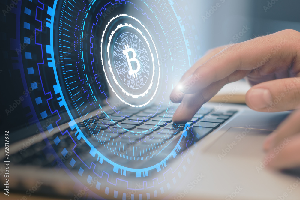 Poster close up of male hands using laptop with creative glowing round bitcoin hologram on blurry backgroun