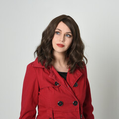 head and shoulders close up portrait of beautiful brunette woman model, wearing red trench coat...