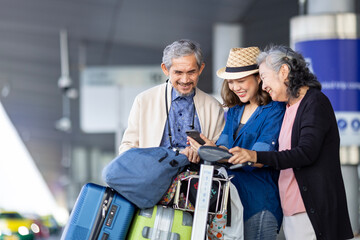 Group of Asian family tourist passenger with senior is using mobile application to call pick up...
