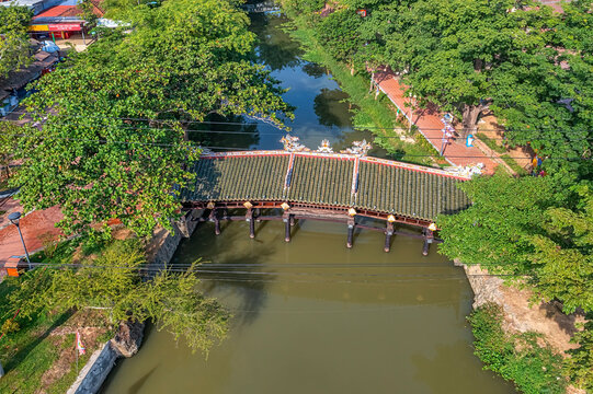 Wonderful view of the "Cau Ngoi Thanh Toan " or Thanh Toan tile bridge near Imperial City with the Purple Forbidden City within the Citadel in Hue, Vietnam.