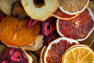 different types of dried berries and fruits on the kitchen table background