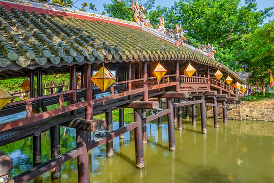 Wonderful view of the "Cau Ngoi Thanh Toan " or Thanh Toan tile bridge near Imperial City with the Purple Forbidden City within the Citadel in Hue, Vietnam.