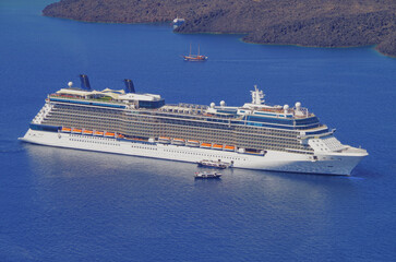 Modern luxury cruiseship cruise ship liner Equinox anchoring in caldera of Santorini Island with...