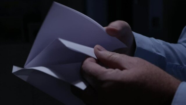 Blurred Shooting with a Person Opening an Envelope and Reading a Letter. Businessman Receiving a Document by Postage.