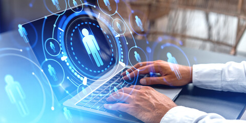 Man typing on laptop computer, people icons and glowing circles