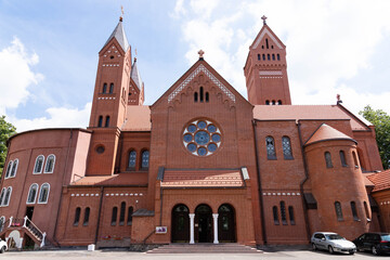 Red church in the city. View from the outside