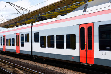 High-speed train at the railway station. Modern passenger train on a railway platform. Railway in Europe. Commercial transport. - obrazy, fototapety, plakaty