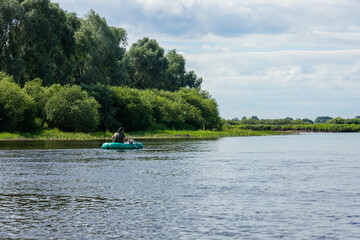 people are floating on the river in an inflatable boat. The concept of outdoor activities and...