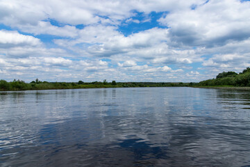 Summer river with bright blue sky and clouds