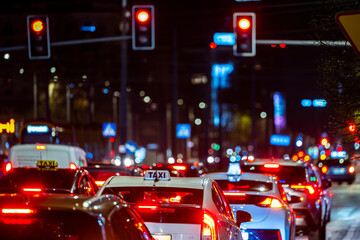 Cars in a traffic jam in the center of a big city at night.