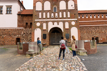 Tourists walk through the ancient castle