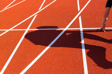 Athletics, treadmill in a stadium with a shadow from a man. Olympic crisis