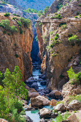 Fototapeta na wymiar Caminito del Rey in the Gaitanes gorge in the province of Malaga, view of the new road over a canyon of the Guadalhorce river, Andalucia.