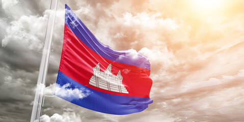 Cambodia national flag cloth fabric waving on beautiful cloudy Background.