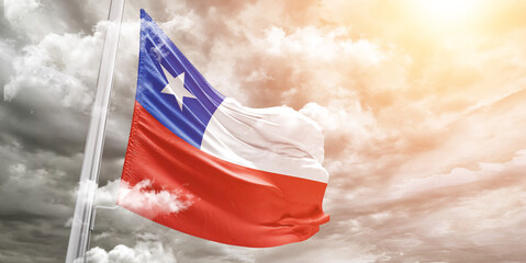 Chile national flag cloth fabric waving on beautiful cloudy Background.