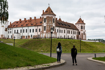 Tourists look at the magnificent view of the ancient Mir Castle, Belarus.