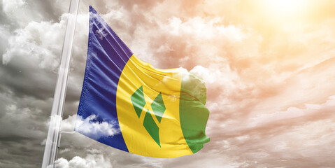 Saint Vincent and the Grenadines national flag cloth fabric waving on beautiful cloudy Background. - obrazy, fototapety, plakaty