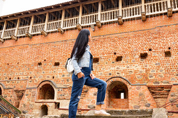A young girl on excursions in an ancient castle. - obrazy, fototapety, plakaty